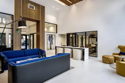 a living room with a blue couch and a table at Luxe Marina Del Rey Apartment,Parking, Gym, Pool, jacuzzi,BBQ in Los Angeles