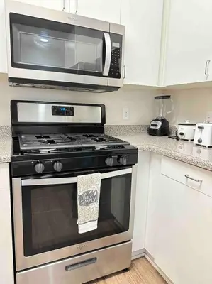 a microwave above a stove in a kitchen at Luxe Marina Del Rey Apartment,Parking, Gym, Pool, jacuzzi,BBQ in Los Angeles