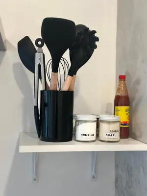 a container of cooking utensils sitting on a shelf at Modern, Remodeled Echo Park House-Walk to Sunset Blvd, Dodgers Stadium, Shops, Bars, Restaurants, Lake, Concerts in Los Angeles