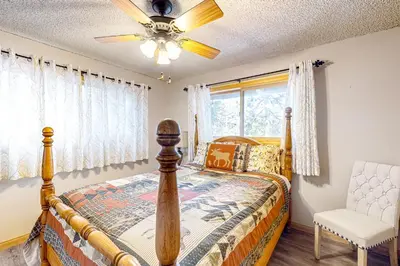 a bedroom with a bed and a ceiling fan at Idyllic Cabin in the Woods Cozy Crestline Retreat in Arrowhead Highlands