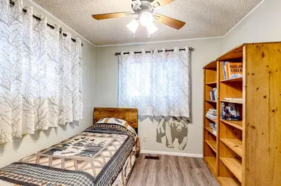 a bedroom with a bed and a window at Idyllic Cabin in the Woods Cozy Crestline Retreat in Arrowhead Highlands
