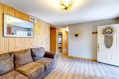 a living room with a couch and a mirror at Idyllic Cabin in the Woods Cozy Crestline Retreat in Arrowhead Highlands