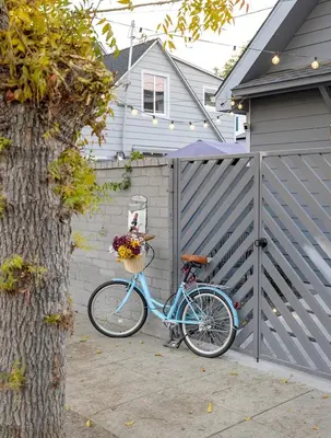 a blue bike parked next to a fence at Hollywood Family Nest in Burbank, Steps to Studios! in Burbank
