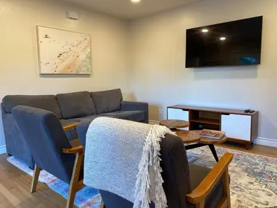 a living room with a couch and a table at Guest house with private entry and large pool in Los Angeles