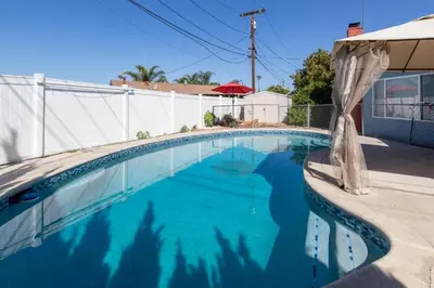 a swimming pool with blue water in a house at Private Room with Laundry and Pool access in Riverside