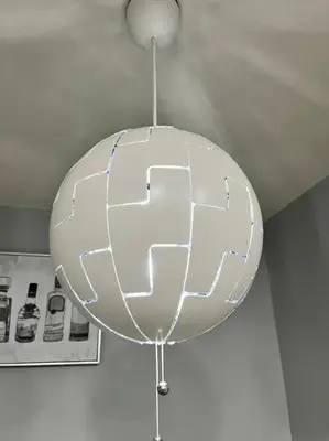 a large white orb hanging from a ceiling at Lux Cozy Experience Elegance in San Bernardino