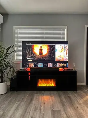 a living room with a flat screen tv and a fireplace at Lux Cozy Experience Elegance in San Bernardino