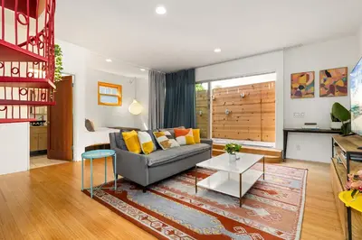 a living room with a couch and a table at Artsy Venice Beach Canals Studio w/Rooftop & Sauna in Los Angeles