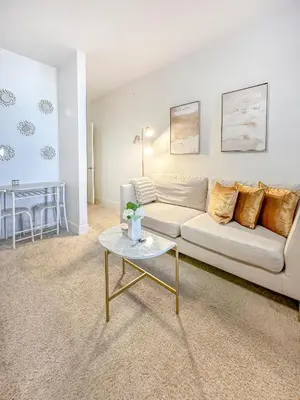 a living room with a white couch and a table at Luxury ApartStudio Marina Del Rey Pool, Gym, Parking, Jacuzzi, BBQ in Los Angeles