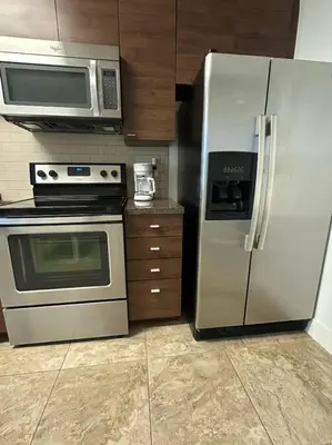 a kitchen with a stainless steel refrigerator and microwave at Luxury ApartStudio Marina Del Rey Pool, Gym, Parking, Jacuzzi, BBQ in Los Angeles