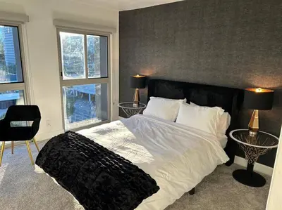a bedroom with a large bed with two tables at Downtown LA - Mamba Suite - Free Indoor Parking! in Los Angeles