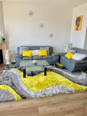 a living room with a couch and a yellow rug at 1 bedroom. 2 beds. 1 bath with Balcony in Los Angeles