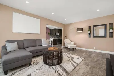 a living room with a couch and a table at Newly Remodeled Home in the Heart of Orange County in Midway City