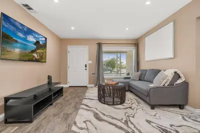 a living room with a couch and a table at Newly Remodeled Home in the Heart of Orange County in Midway City
