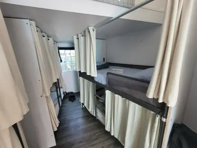 a small room with a bunk bed and curtains at Rumi in Los Angeles