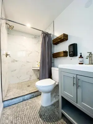 a bathroom with a toilet and a shower and a sink at Rumi in Los Angeles