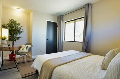 a bedroom with a bed and a desk and a window at Oakridge Ranch ※ Sequoia, Kern River & Lake Escape in Lake Isabella