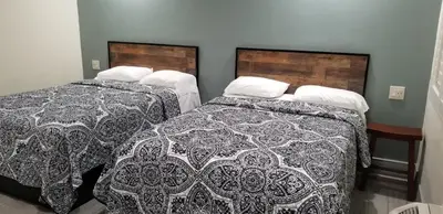 two beds in a hotel room with two beds sidx sidx sidx at Hollywood Park Motel in Inglewood