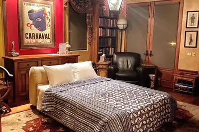 a bedroom with a bed and a black chair at Malibu by the Sea - 5-STARS! in Solromar