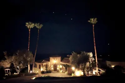 a house at night with palm trees and lights at Malibu by the Sea - 5-STARS! in Solromar