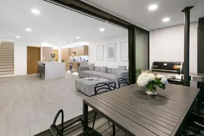 a living room with a table and a couch at Aquazzura - By Stay Awhile Villas in Malibu