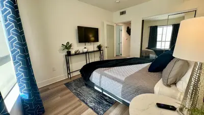 a bedroom with a bed and a tv on the wall at Century City Cozy 3 Bedroom Apartment with Parking 302,303 in Los Angeles