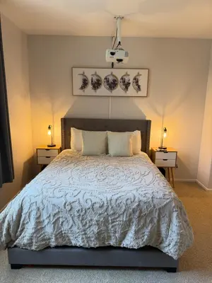 a bedroom with a large bed with two night stands at Canyon Country Cozy Apartment, Pool and Jacuzzi in Santa Clarita
