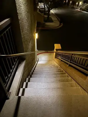 a stairway with two benches and a street at night at Canyon Country Cozy Apartment, Pool and Jacuzzi in Santa Clarita