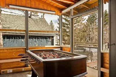 a large pool table in a room with windows at Lil Oso Bonita Cabin in Big Bear Lake