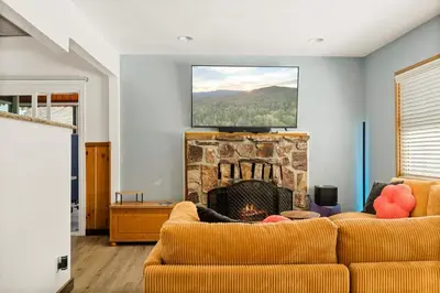 a living room with a couch and a fireplace at Lil Oso Bonita Cabin in Big Bear Lake