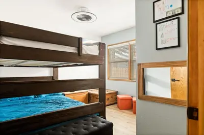 a bedroom with two bunk beds and a mirror at Lil Oso Bonita Cabin in Big Bear Lake