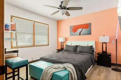 a bedroom with a bed and a ceiling fan at Lil Oso Bonita Cabin in Big Bear Lake