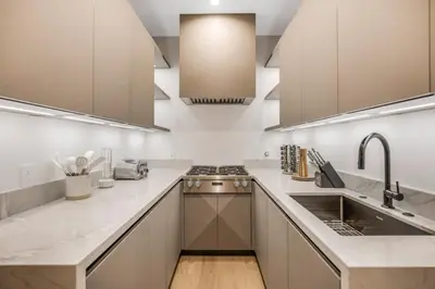 a kitchen with white counters and stainless steel appliances at Levitt Lane in Los Angeles