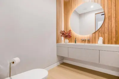 a bathroom with a white toilet and a mirror at Levitt Lane in Los Angeles