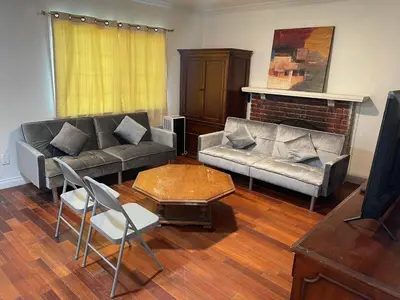 a living room with two couches and a fireplace at Walking Distance Disney in Anaheim in Anaheim
