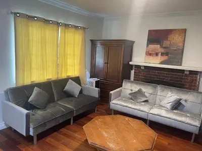 a living room with two couches and a fireplace at Walking Distance Disney in Anaheim in Anaheim