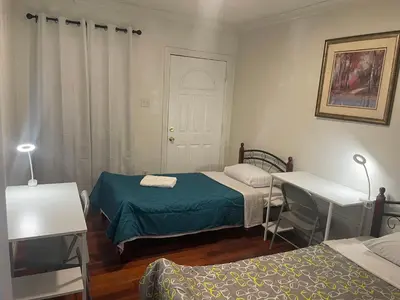a bedroom with two beds and a white door at Walking Distance Disney in Anaheim in Anaheim