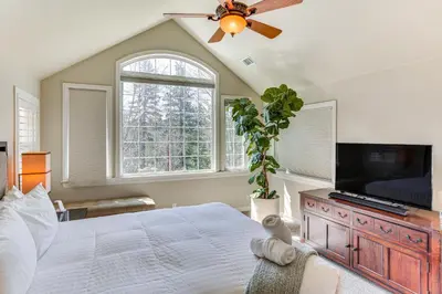 a bedroom with a large bed and a flat screen tv at Lake Arrowhead Home Mountain View, Walk to Water! in Lake Arrowhead