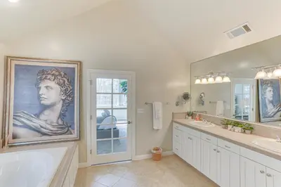 a bathroom with a large painting of a woman at Lake Arrowhead Home Mountain View, Walk to Water! in Lake Arrowhead