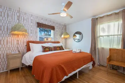 a bedroom with a bed with an orange blanket at Luxe 1-bedroom Gem: Venice Beach Escape in Los Angeles