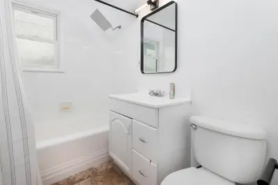 a bathroom with a white toilet and a mirror at Luxe 1-bedroom Gem: Venice Beach Escape in Los Angeles