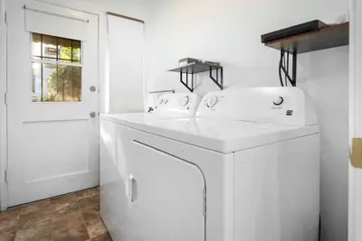 a white kitchen with a washer and dryer at Luxe 1-bedroom Gem: Venice Beach Escape in Los Angeles
