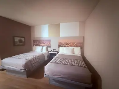 a room with two beds in a hotel room at Hotel Pacific Garden in Gardena