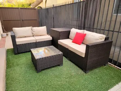 two wicker chairs and a table on a patio at Glamorous Getaway: Exclusive 1BR LA Hotspots in Los Angeles