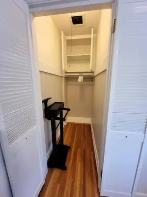 a hallway with a desk in a room with white walls at Glamorous Getaway: Exclusive 1BR LA Hotspots in Los Angeles