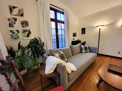 a living room with a couch and a table at Glamorous Getaway: Exclusive 1BR LA Hotspots in Los Angeles