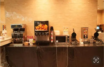 a kitchen with a counter with a microwave and fruit on it at LA Crystal Hotel -Los Angeles-Long Beach Area in Carson
