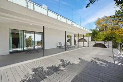 a house with a large deck with glass windows at Stunning Modern 5BR Family Mansion, Panoramic views of Penmar Golf, Pet Friendly! in Los Angeles