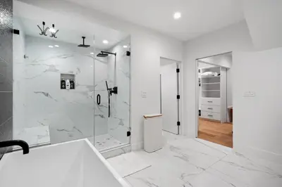 a white bathroom with a shower and a sink at Stunning Modern 5BR Family Mansion, Panoramic views of Penmar Golf, Pet Friendly! in Los Angeles