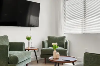 a living room with two chairs and a table at Private Cozy Guest House, King Bed, Parking, Pet Friendly near Penmar Golf Course! in Los Angeles